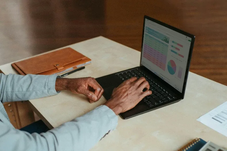 Reviewing financial charts and figures on a laptop