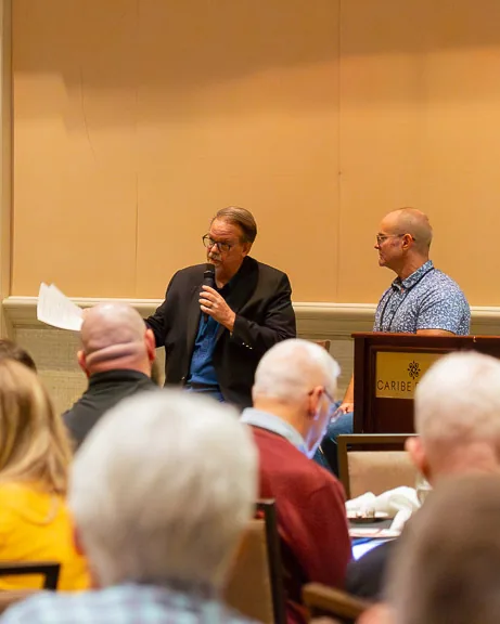 A speaker taking questions from the floor during a session