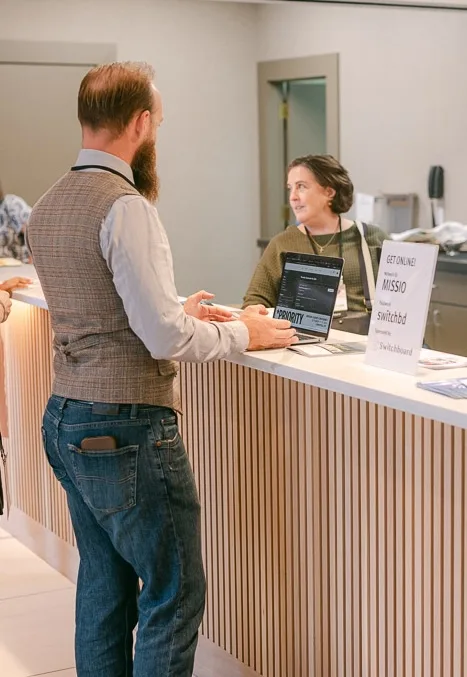 Checking in at the conference registration desk